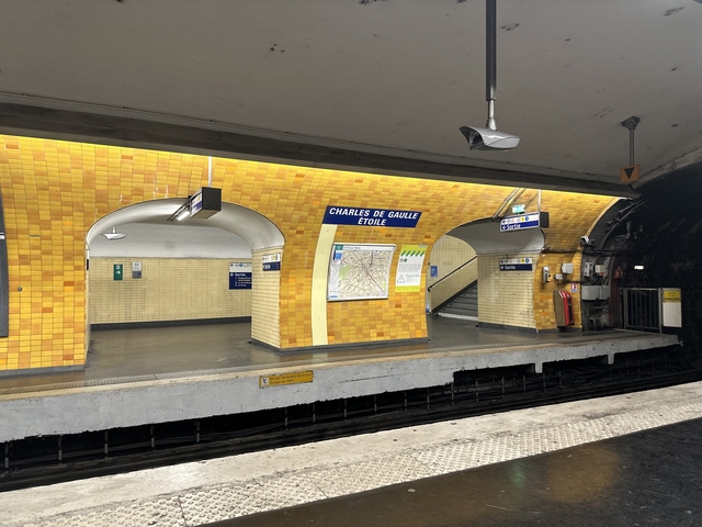 Subway station with yellow tiled walls.