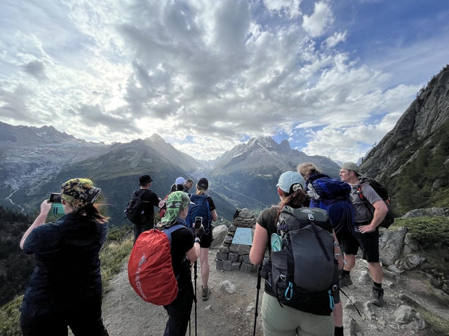 Group of hikers admiring a mountain view.