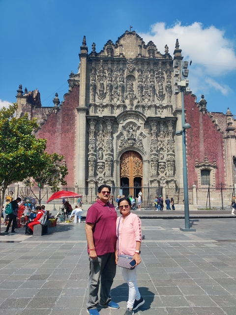 Couple standing in front of an ornate historical building.