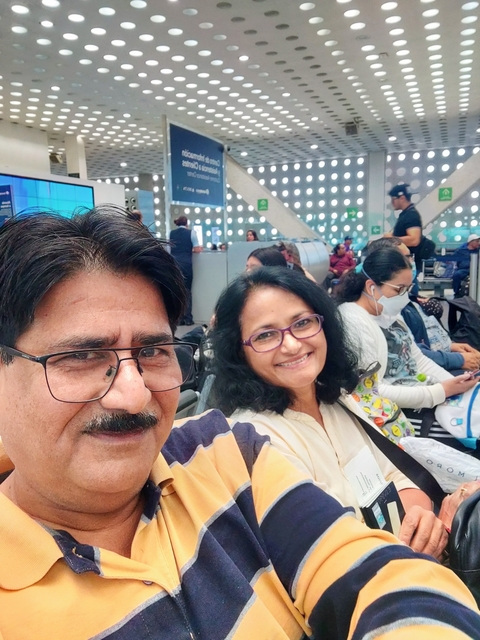 People sitting in an indoor public space, possibly an airport.