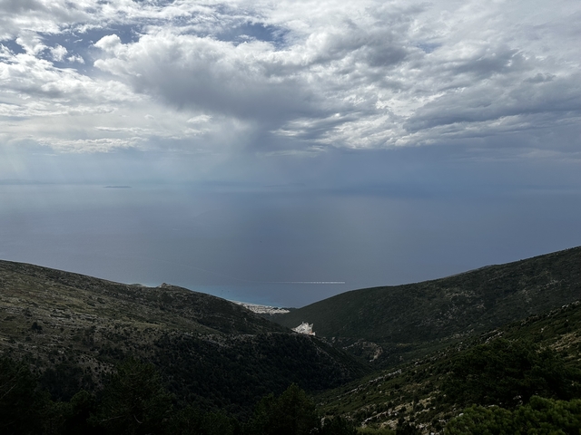 Panoramic view from a mountain overlooking the sea and horizon.
