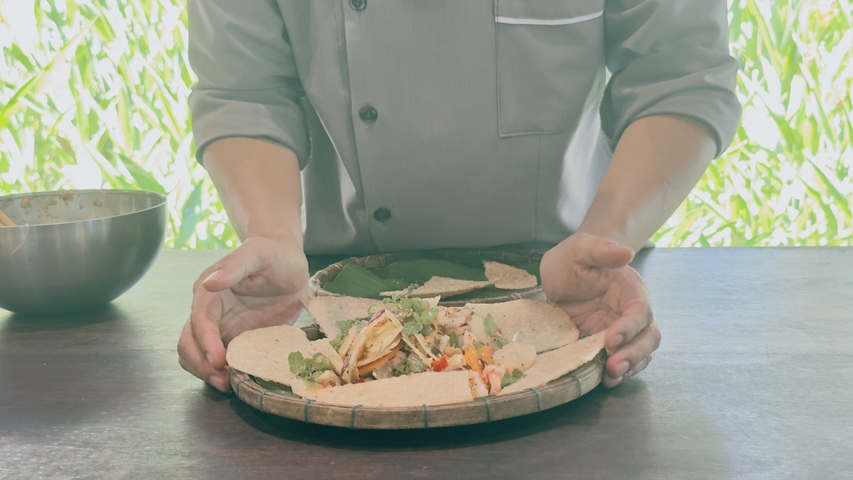 Presentation of a traditional dish on a woven platter.