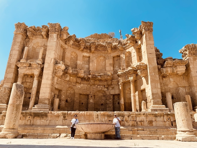 Ancient Roman amphitheater with tourists.