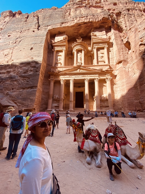 Tourists exploring the ancient structure in Petra.