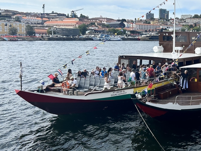 Group of people on a tourist boat in a harbor.