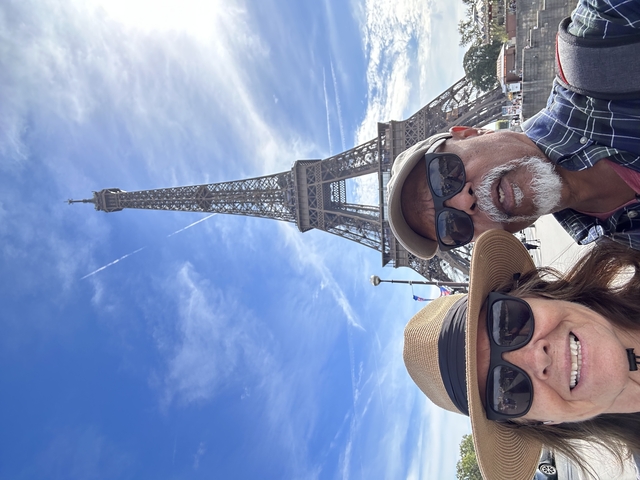 Tourists posing near the Eiffel Tower.