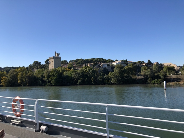View of a river with a castle in the background.