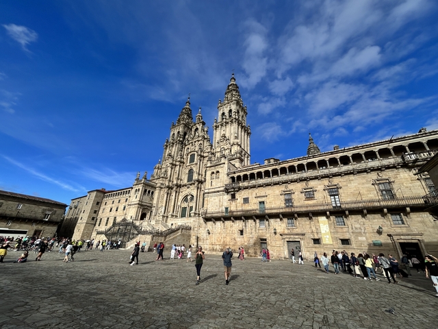       A grand cathedral in a bustling square under a bright sky.
  