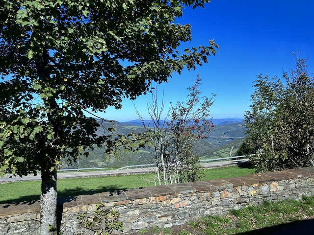 Scenic view of a mountainous landscape with trees in the foreground.