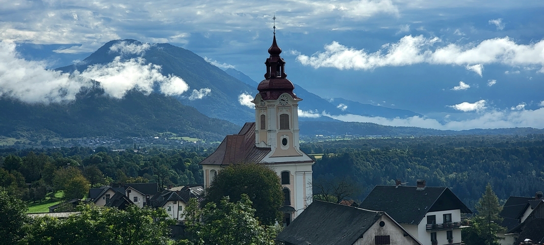 Church with surrounding countryside and mountains.