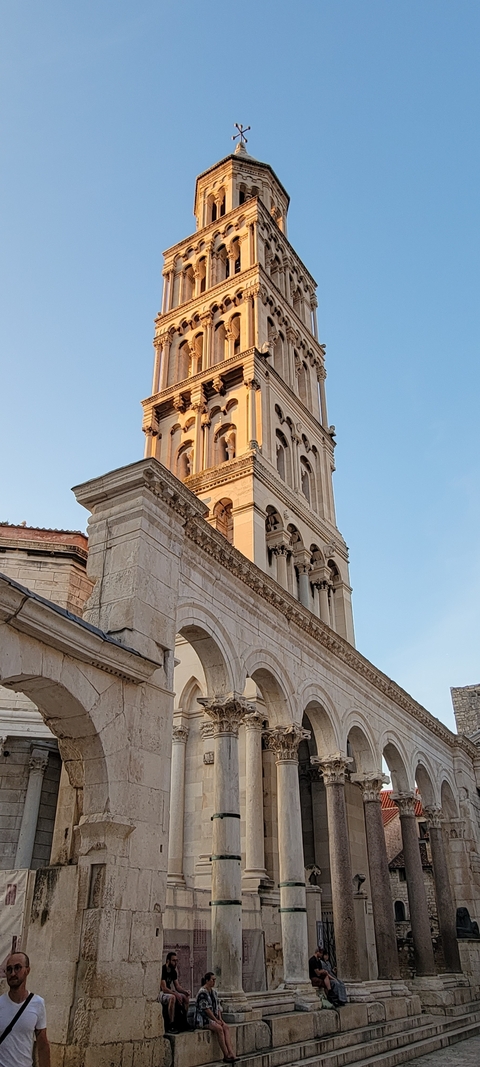 Historical bell tower of a church against a blue sky.