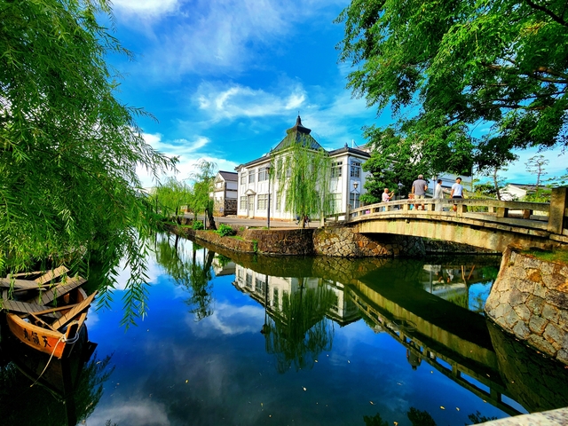 Charming canal with a bridge and people.