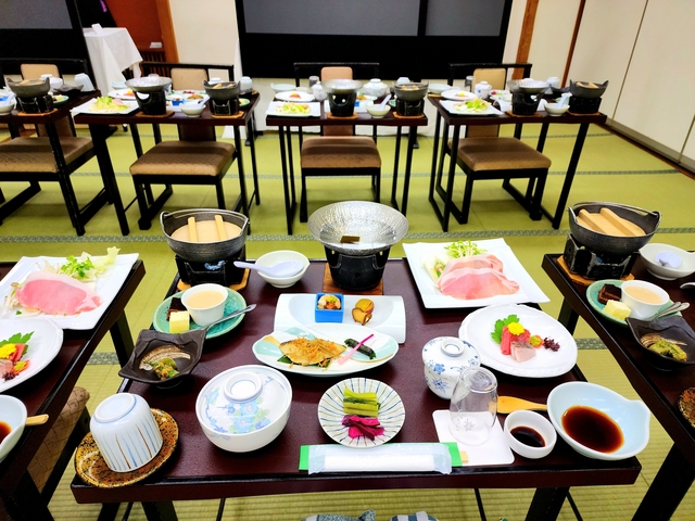Traditional Japanese meal setup with various dishes on a table.