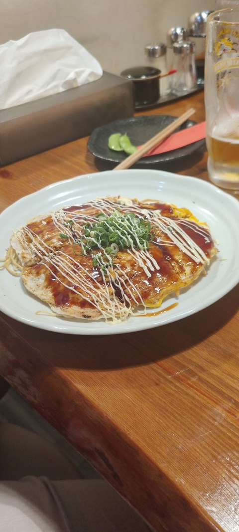 Japanese dish topped with various sauces and garnishes.