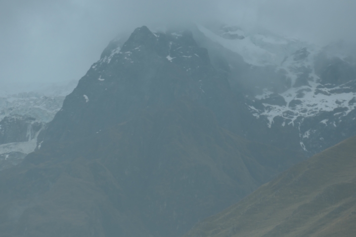 Misty mountain peak with snow.