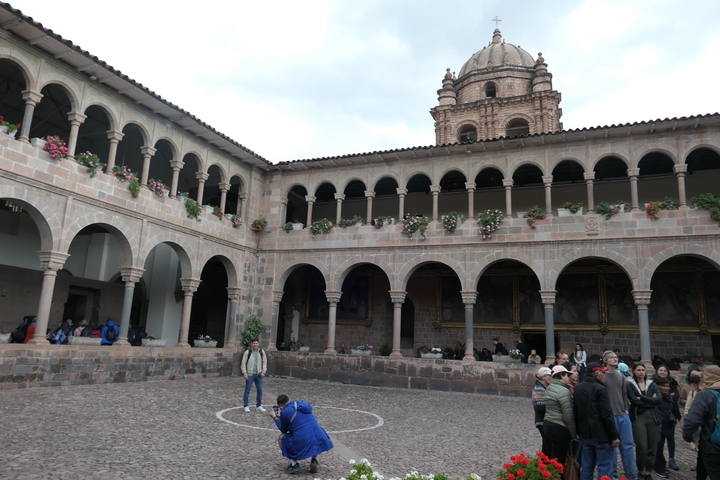 Courtyard with people and historical architecture.