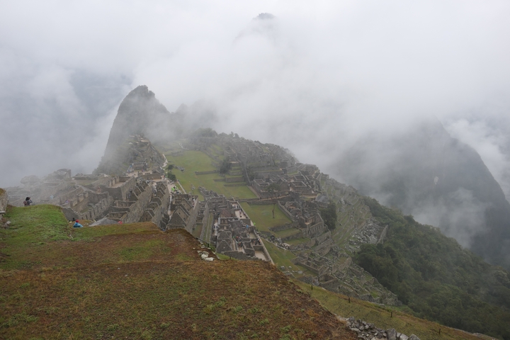       Scenic view of Machu Picchu ruins with fog.
  