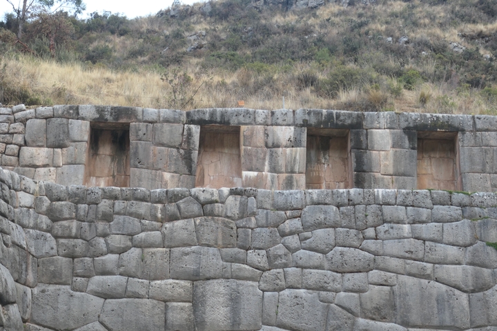      Stone structures with window openings in a historical site.
  
