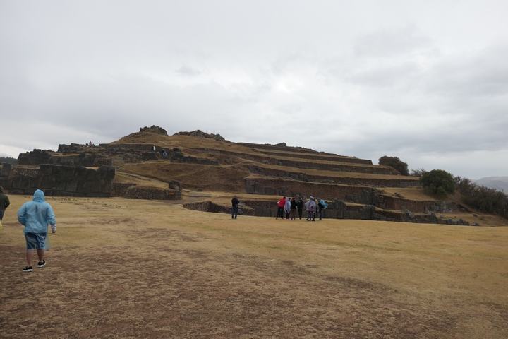       Group of people exploring ancient ruins.
  