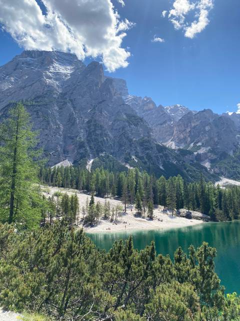 Lake with mountains and a beach.