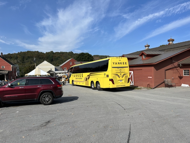 Large yellow bus with 'YANKEE' written on it.