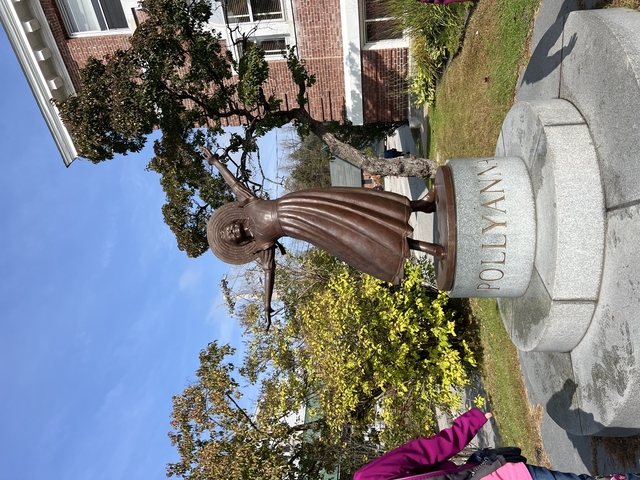 Pollyanna statue in a garden setting.