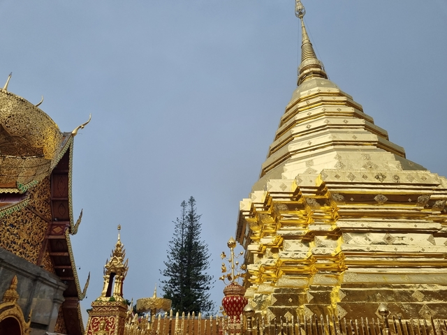 Golden pagoda in detail against a blue sky.