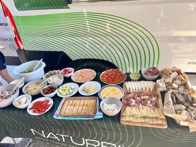 Buffet of assorted foods including cheese and meats.