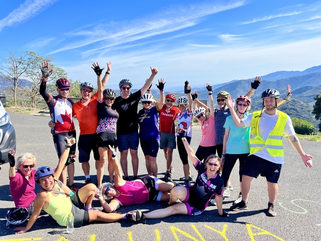 Happy group of cyclists celebrating with cheers.