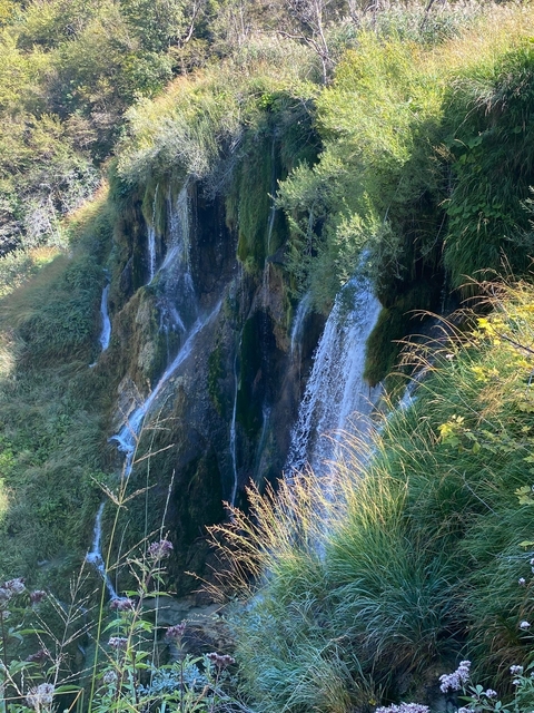 Waterfall cascading down a moss-covered cliff.