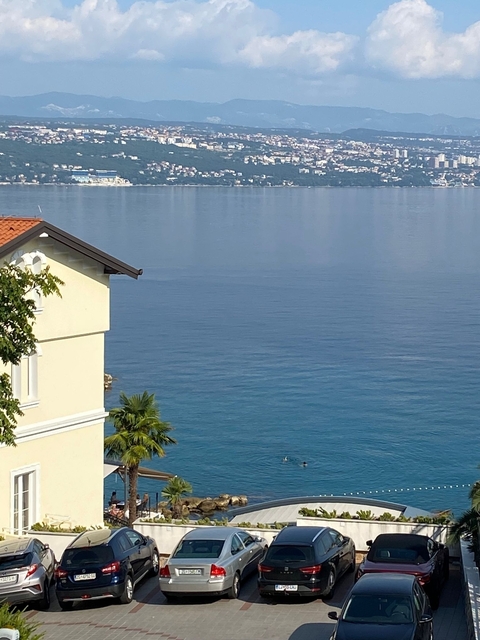 A building beside a calm water surface.
