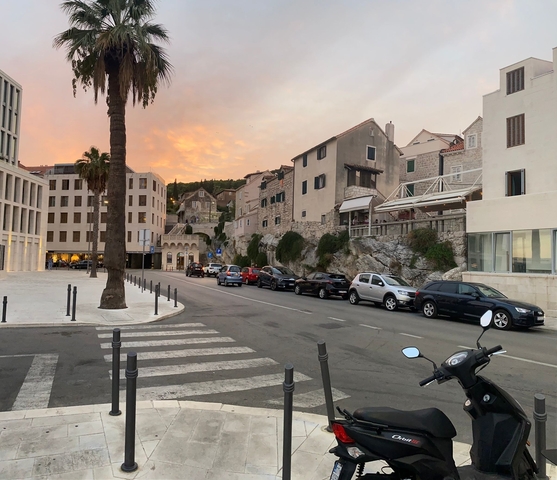 Street in a historic town with a sunset sky.
