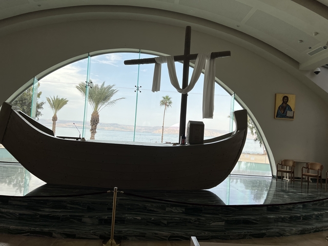       Interior view of a church through a boat-shaped altar.
  