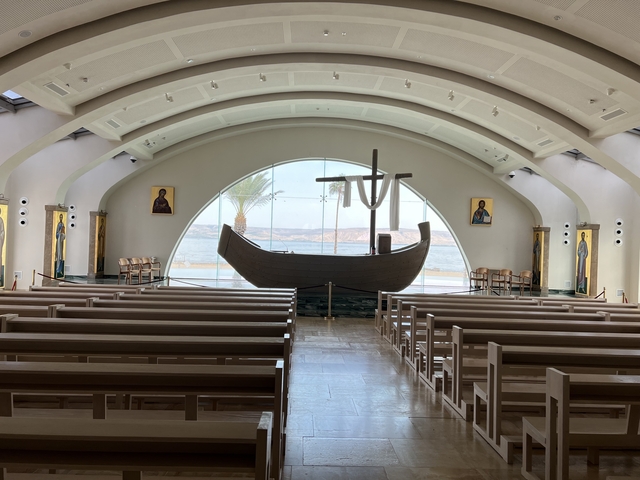 Church interior with benches and a boat-shaped altar.