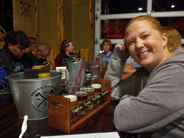 Group of people enjoying drinks in a pub setting.
