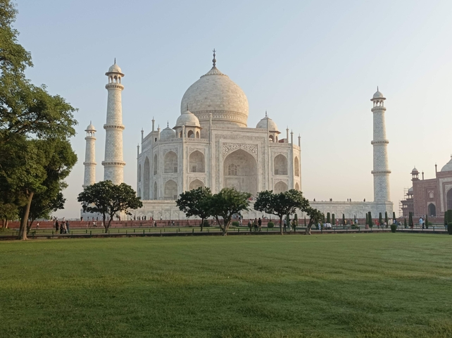The Taj Mahal in Agra with green lawns in the foreground.