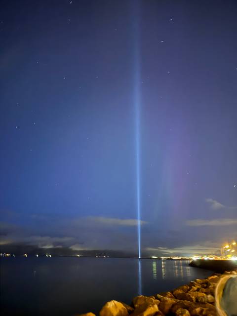 Beam of light in the night sky.