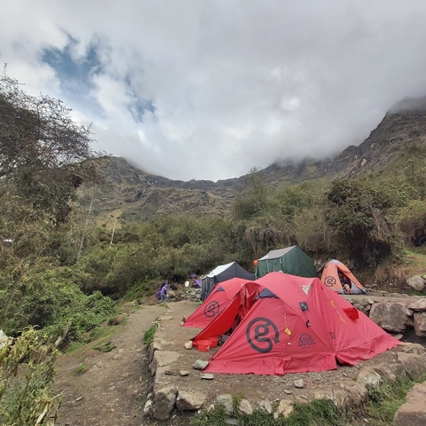      Camping tents in a mountainous outdoor setting.
  