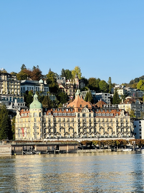 Upscale hotel building with hill in the background.