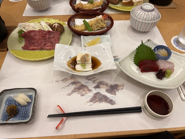       Japanese meal set with various dishes on a table.
  