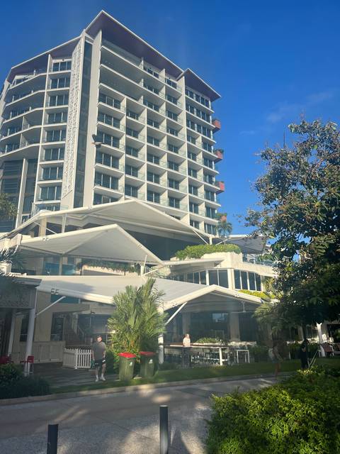       Building with balconies against a bright blue sky.
  