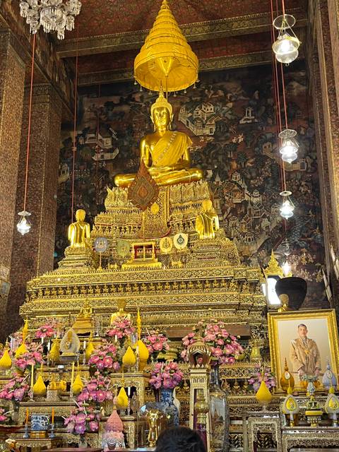 Elaborate golden temple interior with statues.