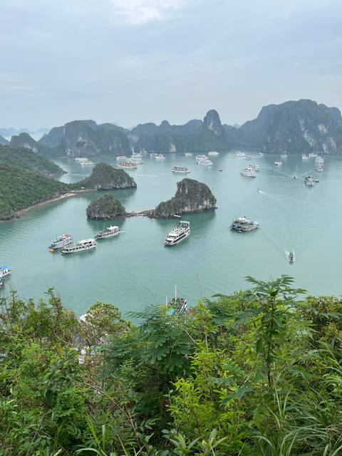 Aerial view of Halong Bay with boats and karst formations.