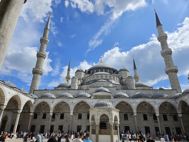       Sultan Ahmed Mosque with blue sky and clouds.
  