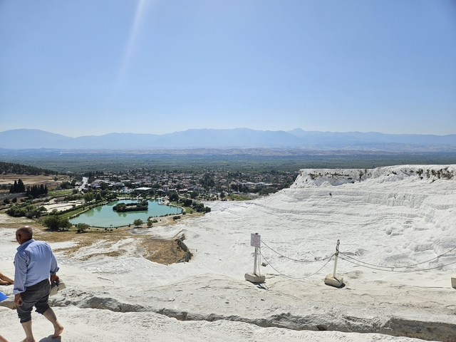       Scenic view of Pamukkale with people on terraces.
  