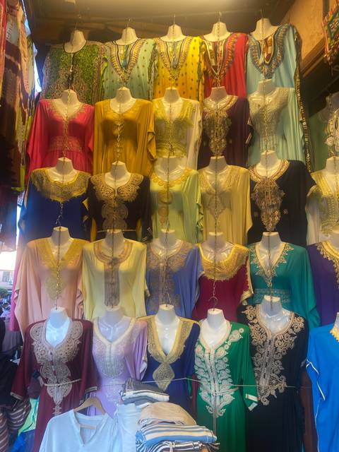       Colorful clothing display in a market.
  