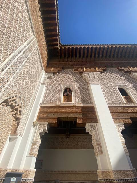 Intricate ceiling architecture with two people peeking through.