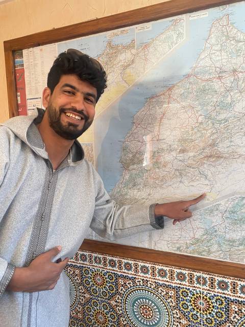       Person pointing at a large map.
  