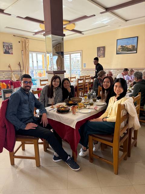       Group of people dining in a traditional setting
  