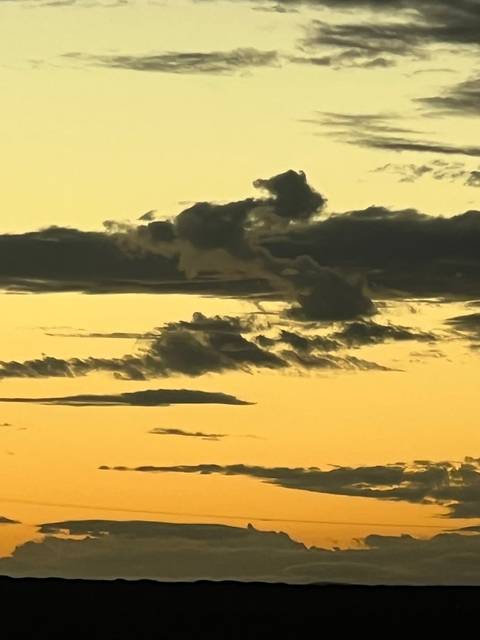 Sky with clouds lit by sunset hues.